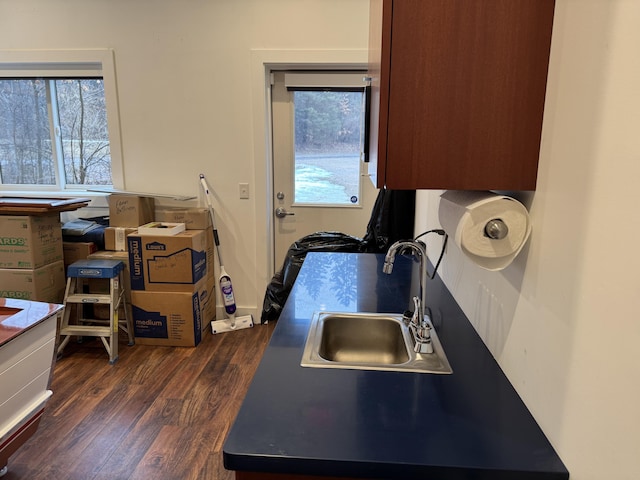 kitchen with dark wood finished floors and a sink