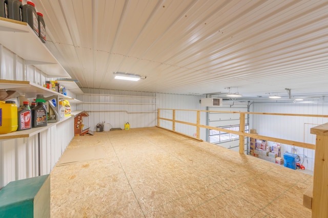 misc room featuring a garage and metal wall