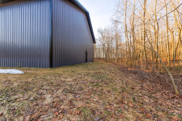 view of side of home featuring an outbuilding