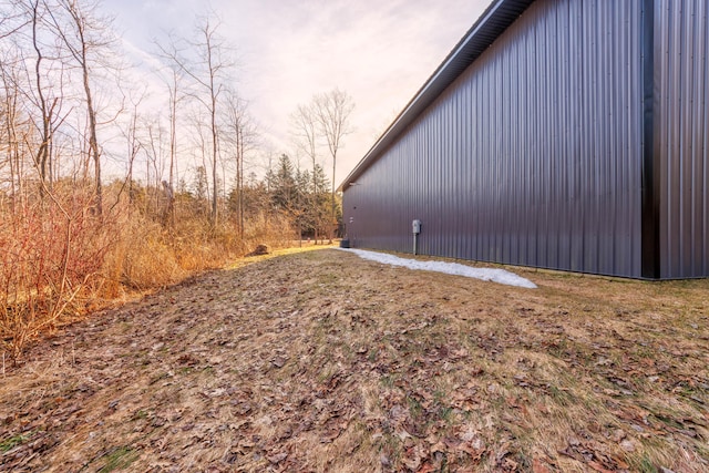 view of side of home featuring an outbuilding and an outdoor structure