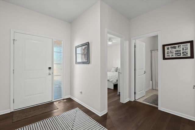 entryway with baseboards and dark wood-style floors