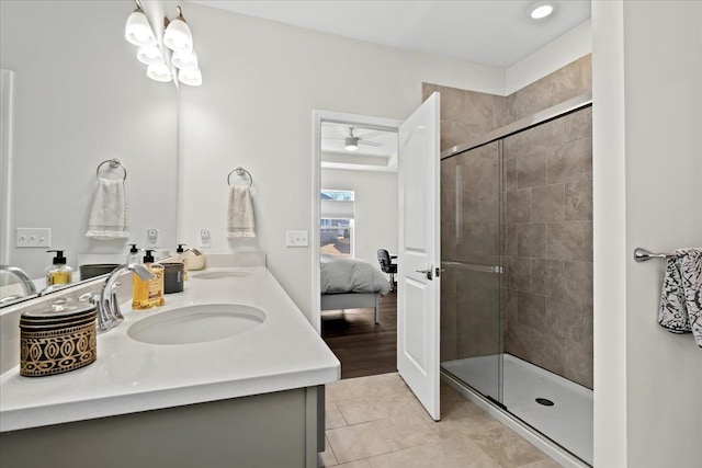 ensuite bathroom featuring a shower stall, connected bathroom, tile patterned floors, and a sink