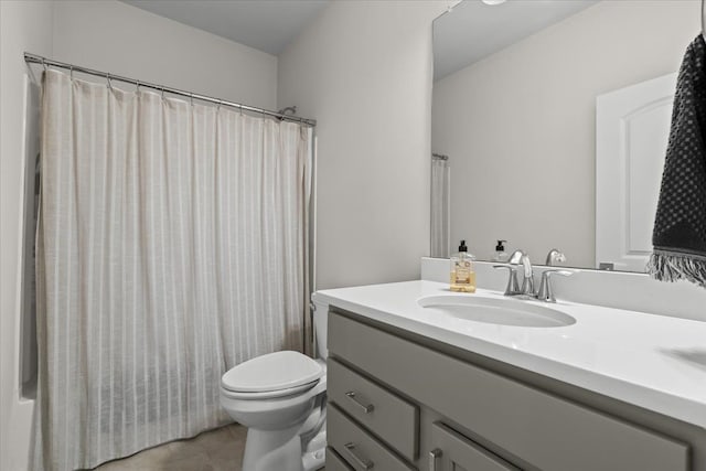 bathroom featuring vanity, curtained shower, and toilet