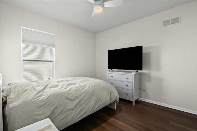 bedroom featuring a ceiling fan, dark wood-type flooring, baseboards, and visible vents