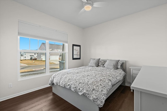 bedroom with dark wood finished floors, baseboards, and ceiling fan