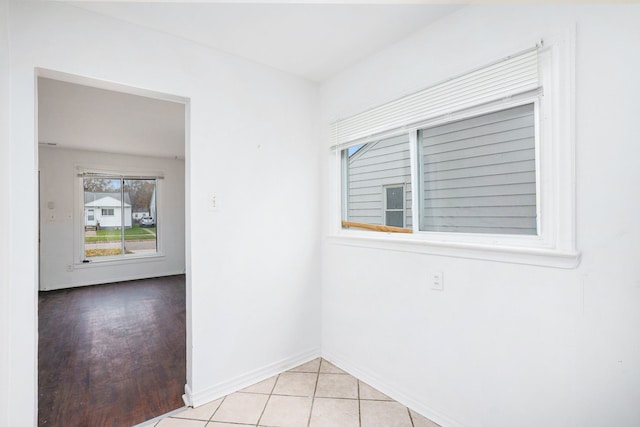 empty room with tile patterned flooring and baseboards