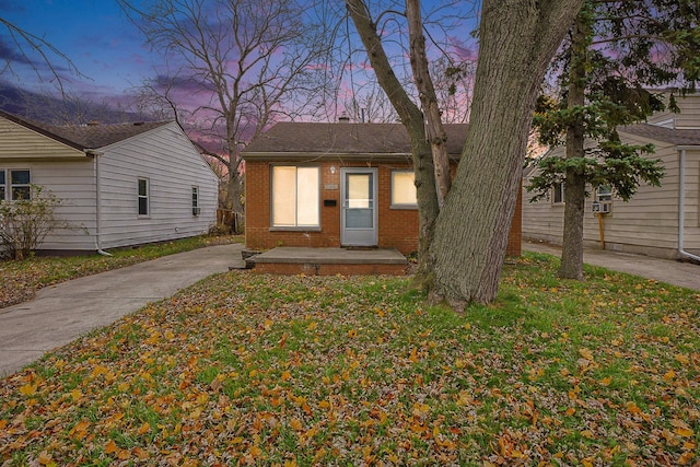 view of front facade featuring a yard and brick siding