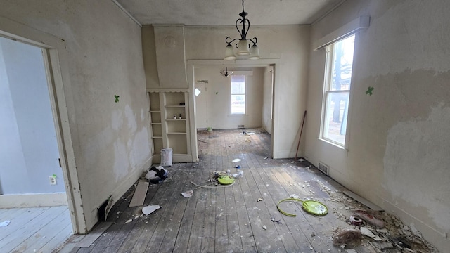 77 Irwin Ave, Muskegon, MI 49442 - unfurnished dining area featuring visible vents and hardwood / wood-style flooring
