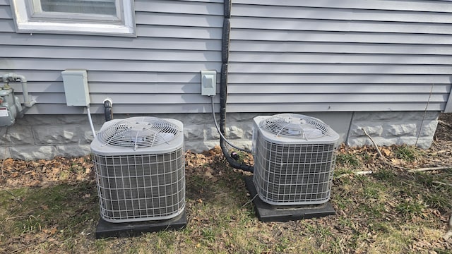 77 Irwin Ave, Muskegon, MI 49442 - exterior details featuring gas meter and central AC