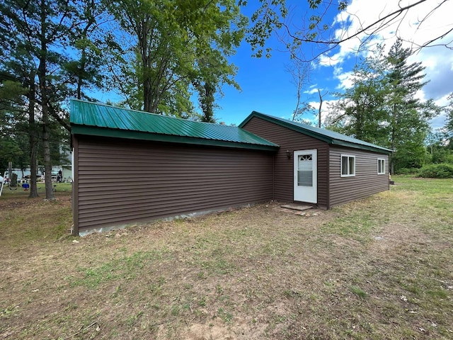 rear view of property with metal roof