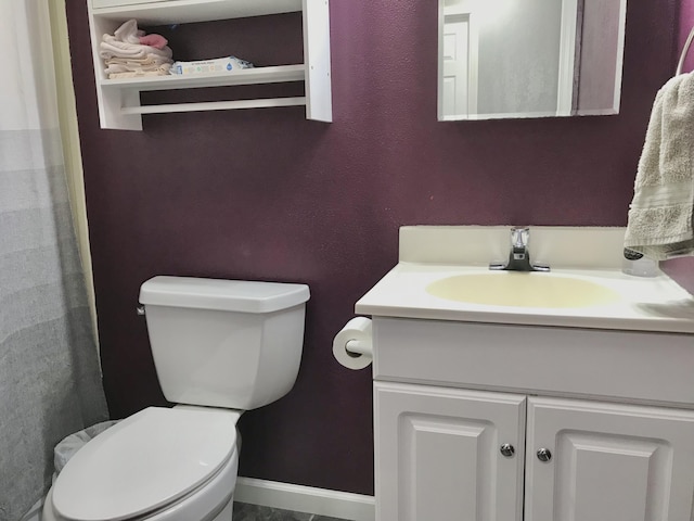 full bathroom featuring toilet, vanity, and baseboards