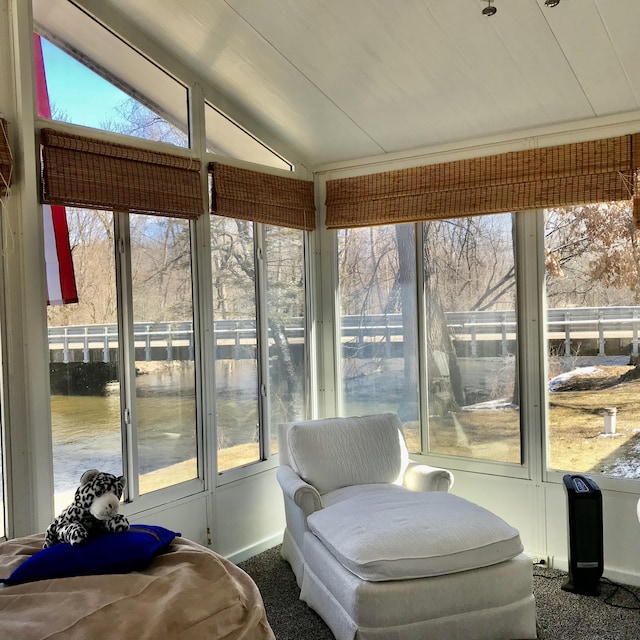 sunroom / solarium featuring vaulted ceiling and plenty of natural light