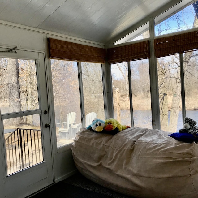 sunroom / solarium featuring vaulted ceiling