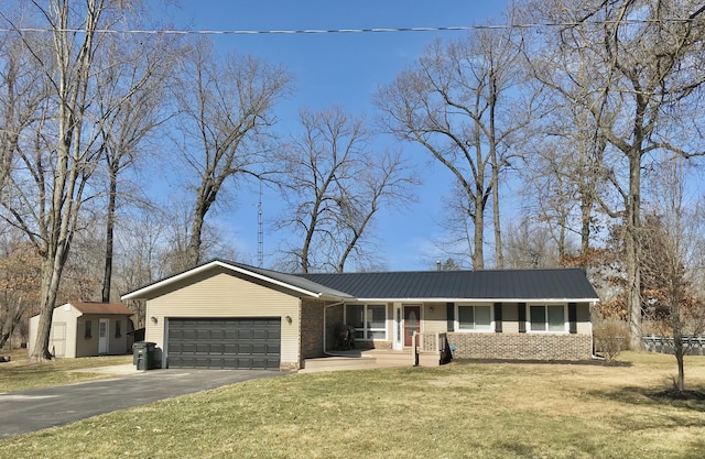 ranch-style home with driveway, a garage, a front yard, and brick siding