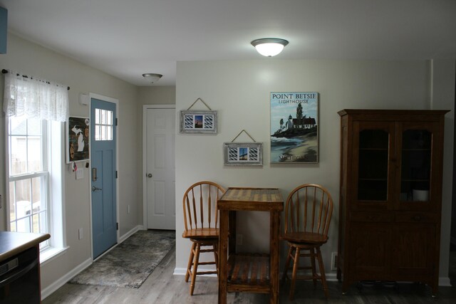 dining area with wood finished floors and baseboards