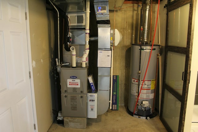 utility room featuring gas water heater and visible vents