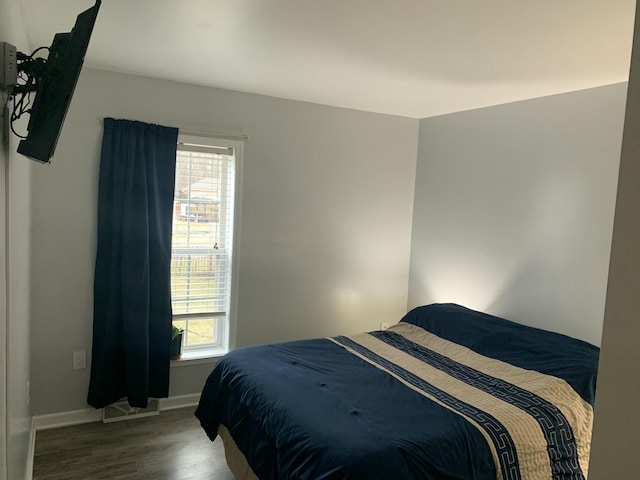 bedroom featuring baseboards and wood finished floors