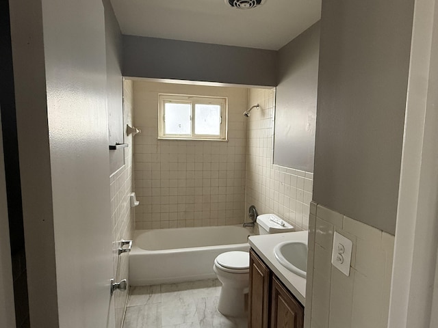 bathroom with marble finish floor, bathing tub / shower combination, vanity, and toilet