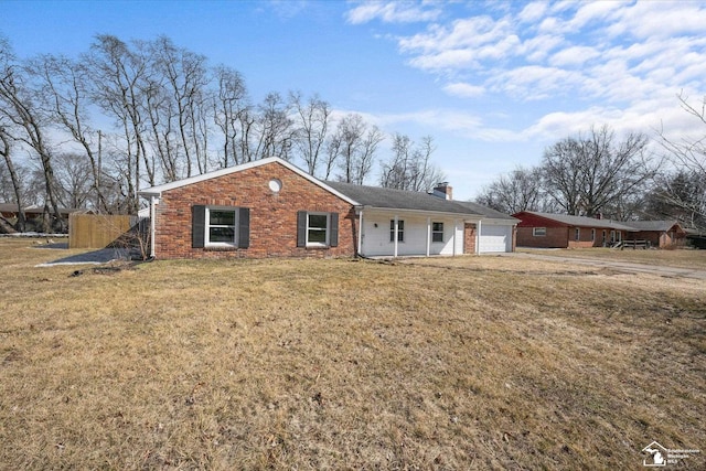 single story home featuring a front lawn, brick siding, a garage, and a chimney