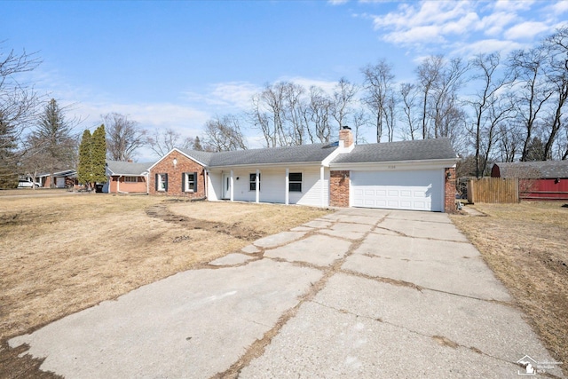 ranch-style house featuring a garage, brick siding, fence, driveway, and a chimney