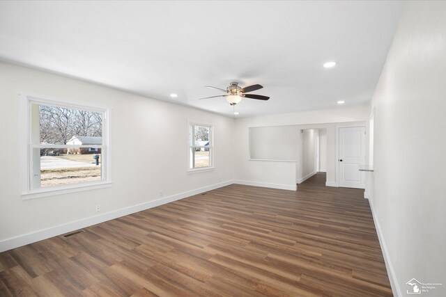 spare room featuring baseboards, visible vents, ceiling fan, dark wood-style flooring, and recessed lighting