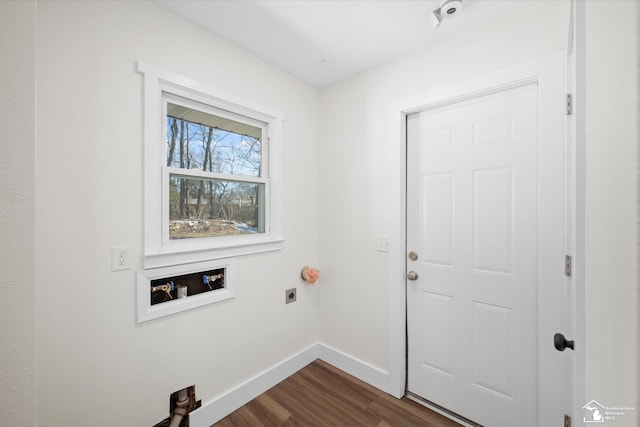 laundry room with laundry area, baseboards, dark wood-type flooring, hookup for a washing machine, and electric dryer hookup