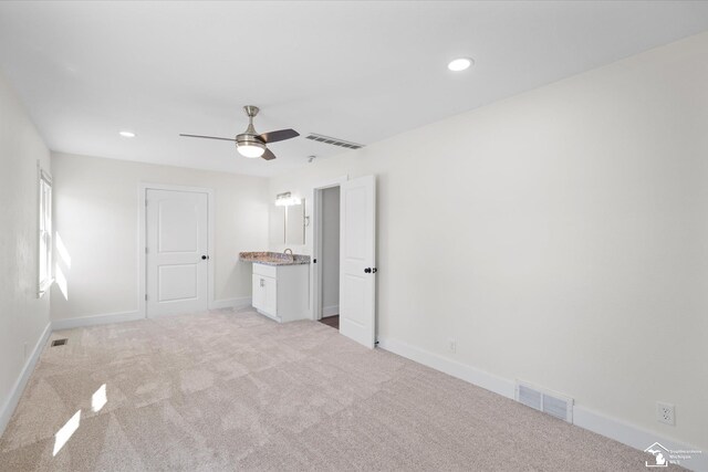 unfurnished bedroom with baseboards, visible vents, and light colored carpet