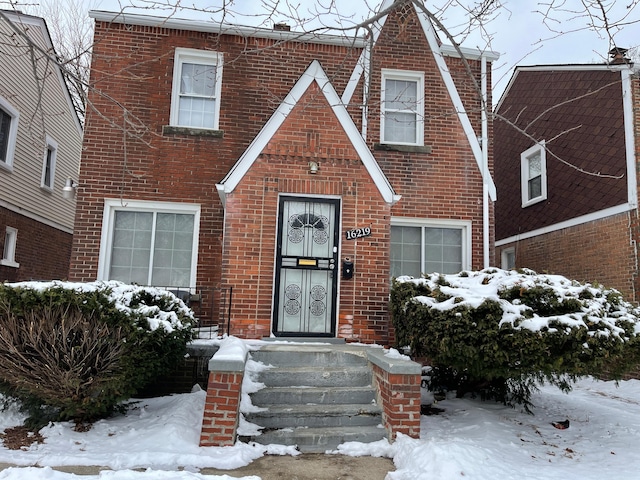 english style home with brick siding