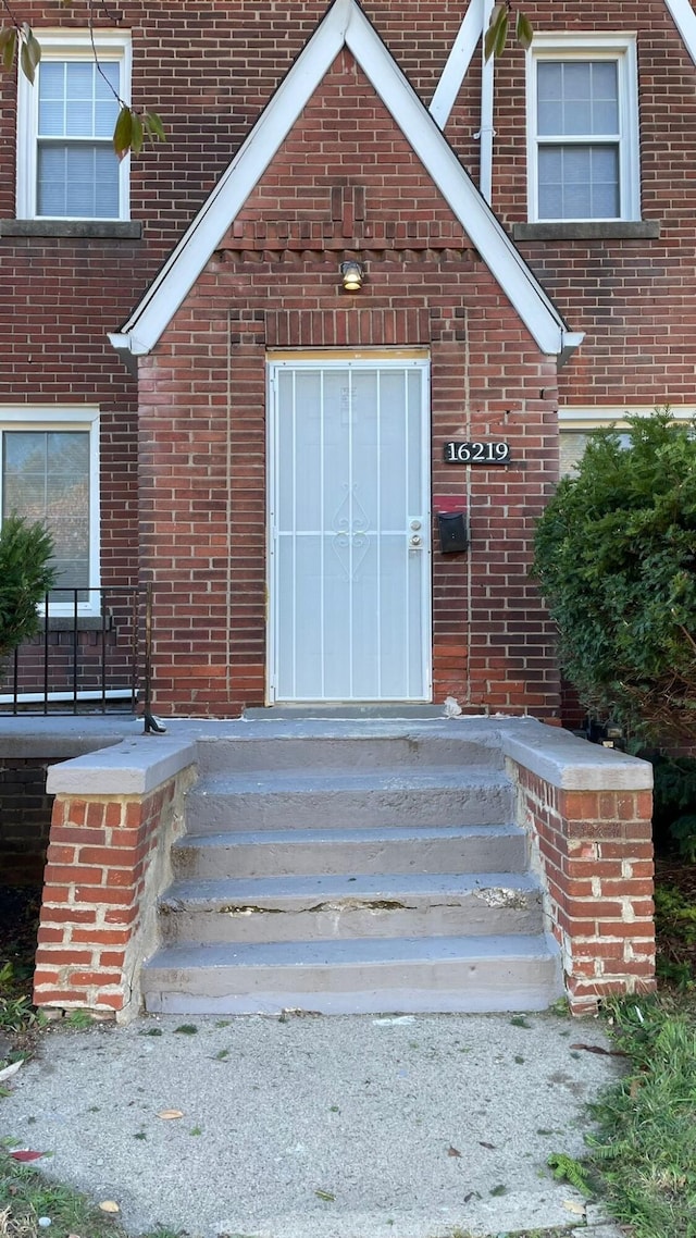 entrance to property with brick siding