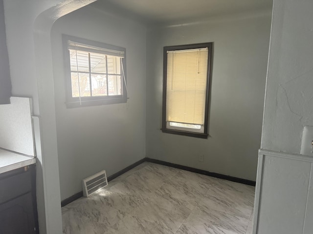 interior space featuring marble finish floor, visible vents, and baseboards