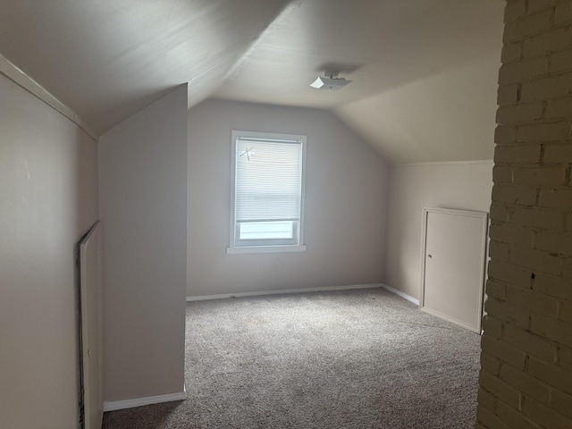 bonus room with vaulted ceiling, carpet, and baseboards