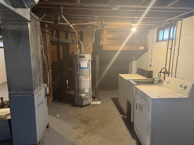 below grade area featuring water heater, washer and clothes dryer, and heating unit