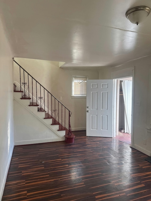 entrance foyer featuring stairs, baseboards, and wood finished floors