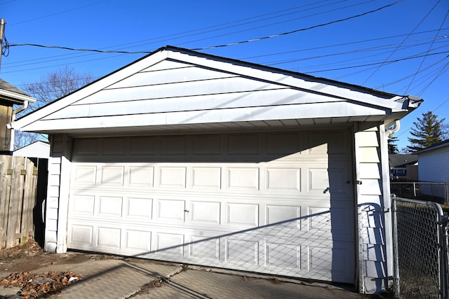 detached garage featuring fence