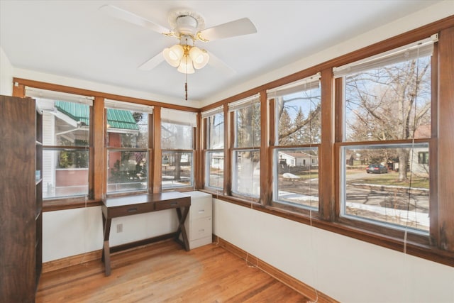 sunroom with plenty of natural light and ceiling fan