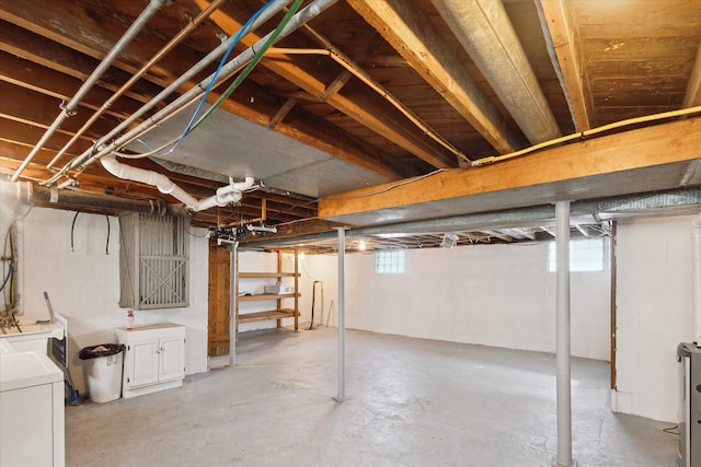 below grade area featuring plenty of natural light and washer / clothes dryer