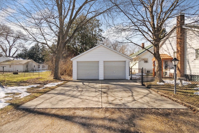 detached garage featuring a gate and fence