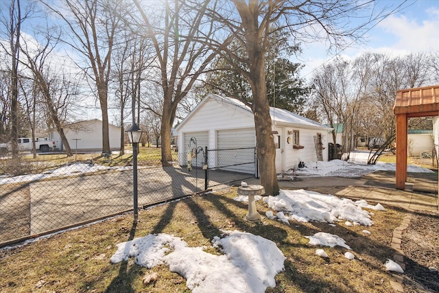 exterior space with an outbuilding, a garage, and fence