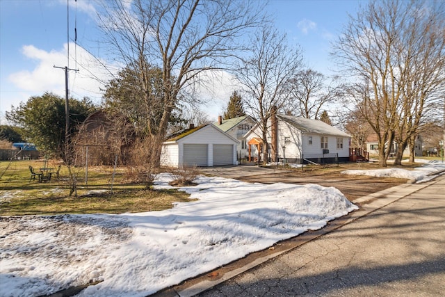 view of front of home featuring a detached garage and an outdoor structure