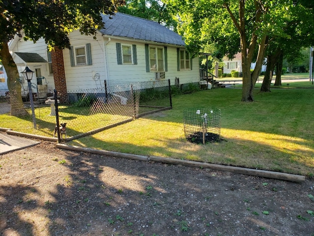 view of front of home featuring a shingled roof, a front yard, and fence