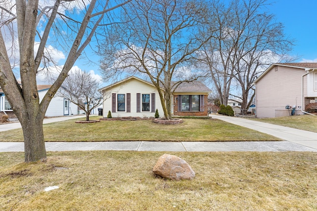 view of front of house featuring a front yard and brick siding