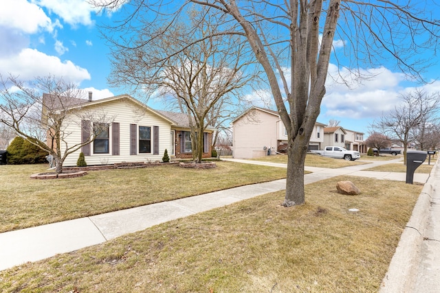 view of front of home with a front yard and a residential view