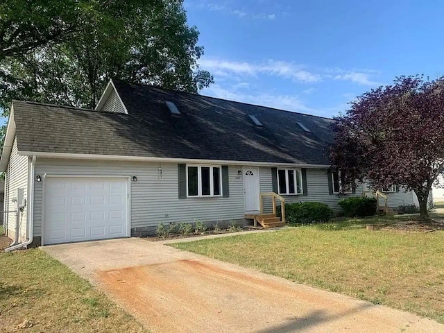 view of front of property with concrete driveway, a shingled roof, an attached garage, and a front yard