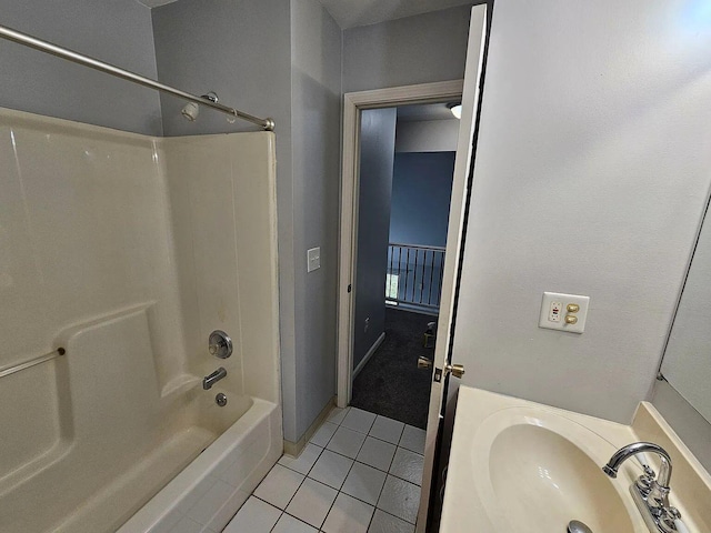 bathroom with bathtub / shower combination, a sink, and tile patterned floors