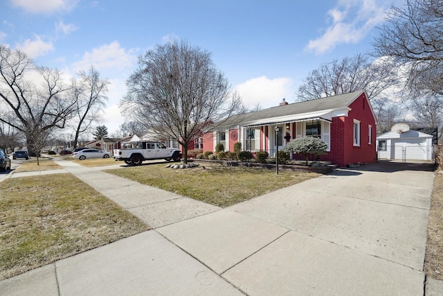 exterior space featuring an outbuilding, brick siding, a chimney, and a front lawn