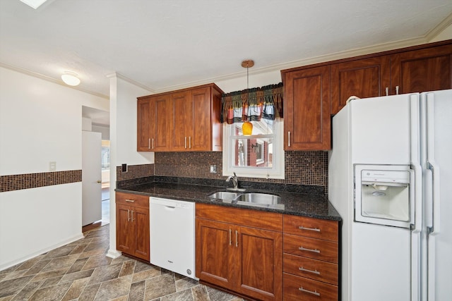 kitchen featuring decorative backsplash, white appliances, stone finish flooring, and a sink