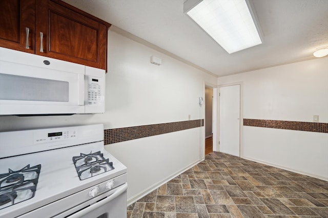 kitchen with white appliances and stone finish flooring