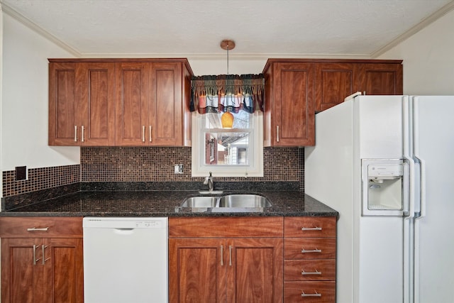 kitchen with decorative backsplash, white appliances, crown molding, and a sink