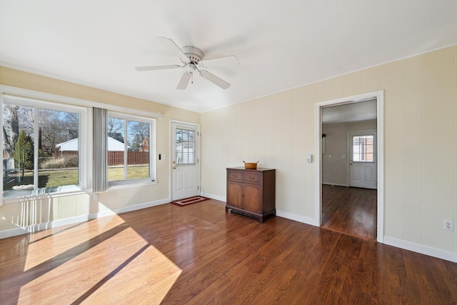 entryway featuring ceiling fan, baseboards, and wood finished floors