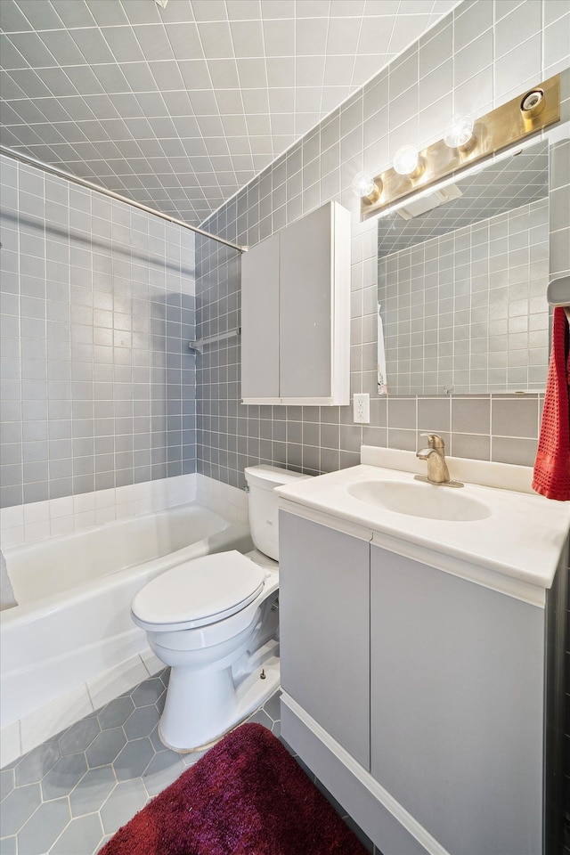 full bath with vanity, decorative backsplash, tile walls, toilet, and tile patterned floors